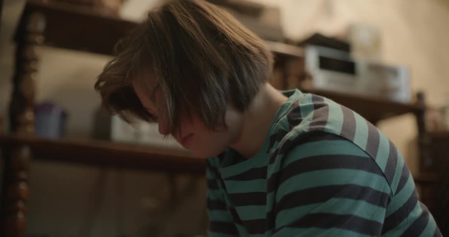 Young girl playing with a tabletop game of ice hockey at home