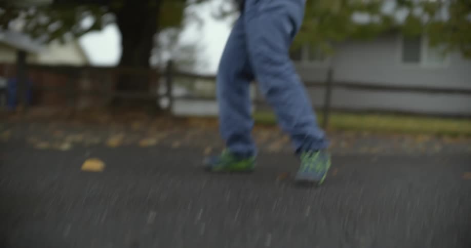 Teenage girl practices hockey on a neighborhood street