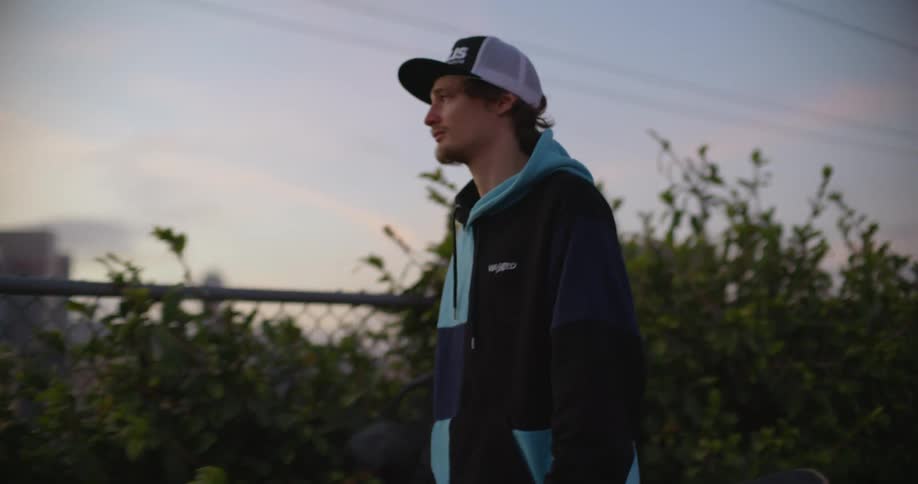 A man is walking around and looking at the city skyline