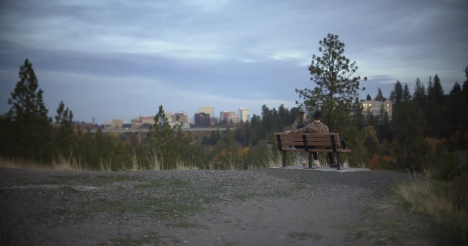 Two people sit on the bench in the park