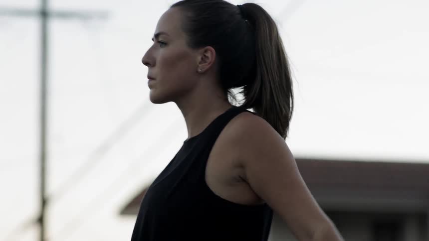A woman stretches outdoors