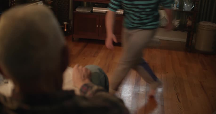 A child dashes back and forth in the living room
