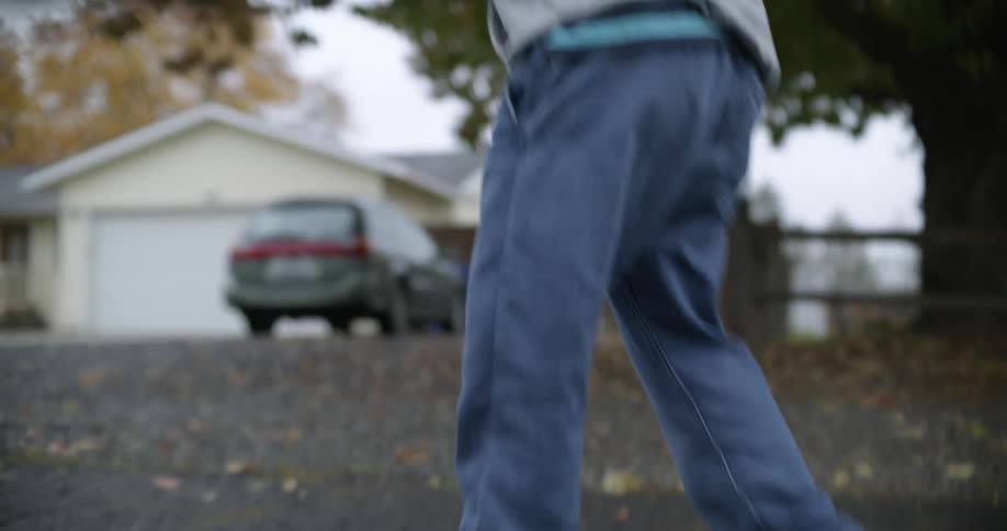 Young girl practices hockey on the streets of the neighborhood