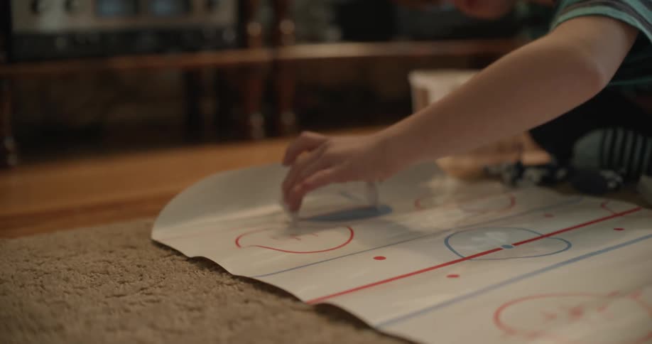 A child putting together a hockey toy in a room
