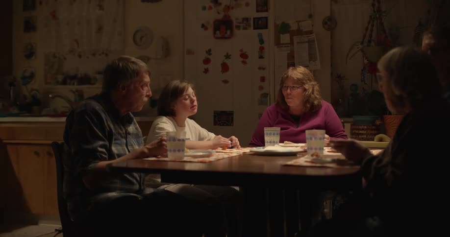 A family is sitting in a restaurant at a table eating pizza