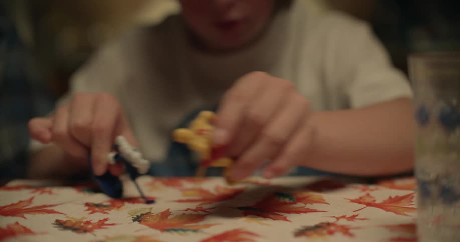 Teenage girl plays with hockey player figures on table
