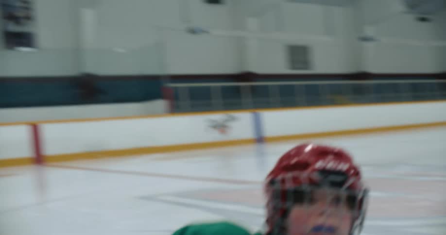 A hockey player skates on the ice and then falls and slides on their knees