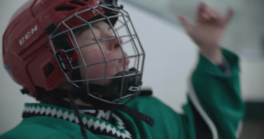 A girl closes the face guard on her helmet
