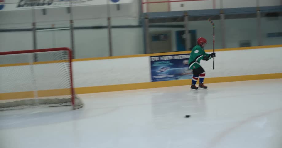 A person playing hockey in an indoor rink