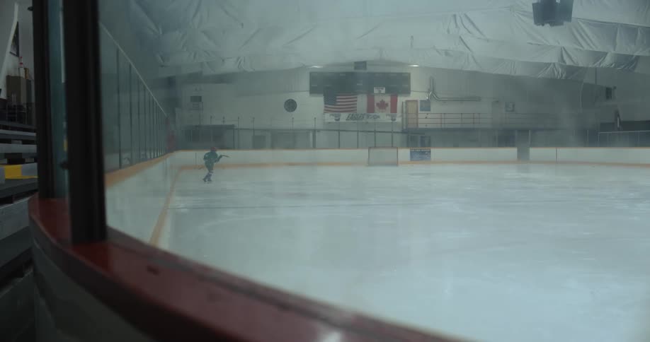 A child skates across a hockey rink