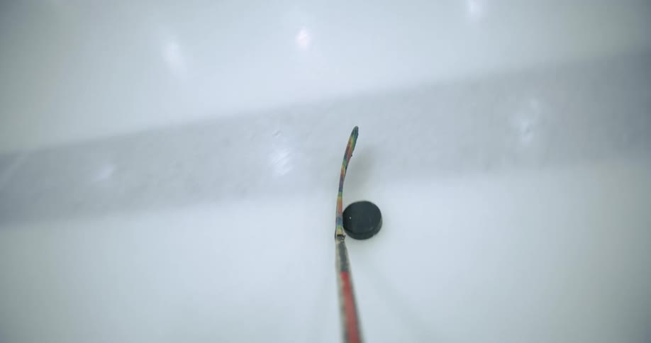 Hockey stick controlling the puck down the ice