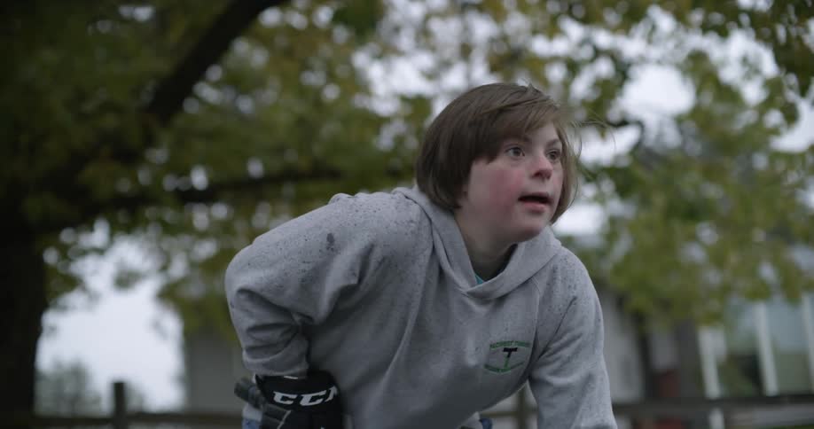 A girl is playing street hockey in town