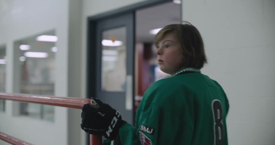 A hockey player walking out of a room