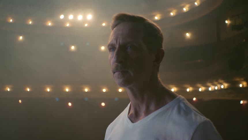 A man searches around the stage