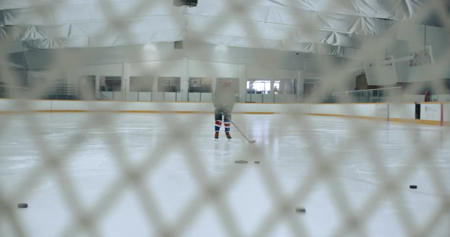 A view of a person hitting a hockey puck