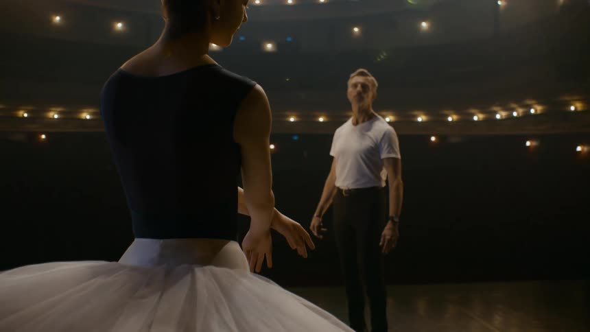 A man and woman stand on the stage together