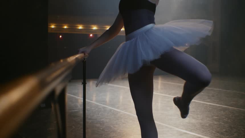 Ballerina practicing on stage in empty theater