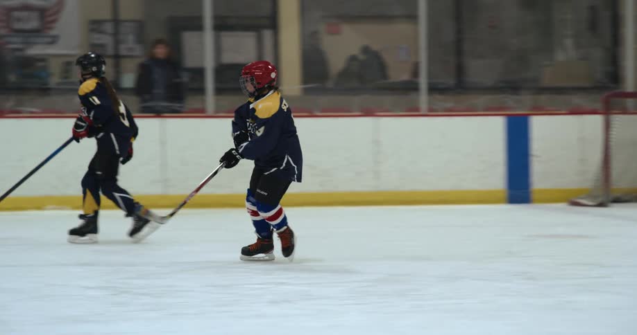 Two teams of young hockey players practicing on the rink