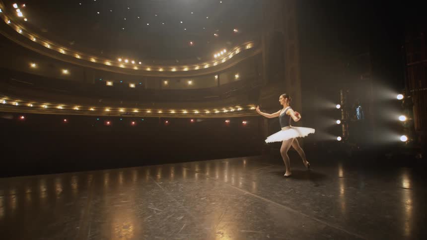 A woman is performing ballet on the stage