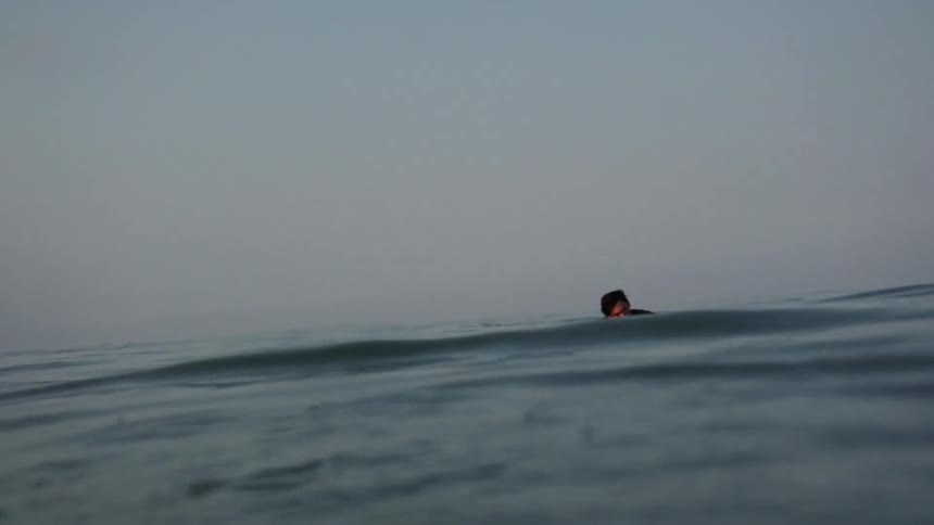 A person rides a surfboard