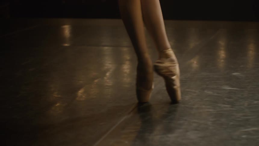 A ballerina spins on a stage in a theater