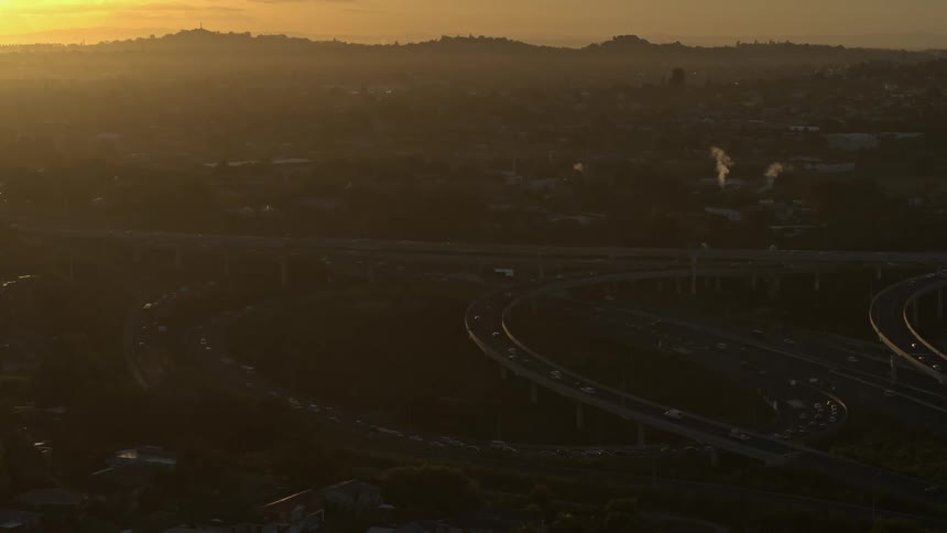A large highway interchange in a town at sunset