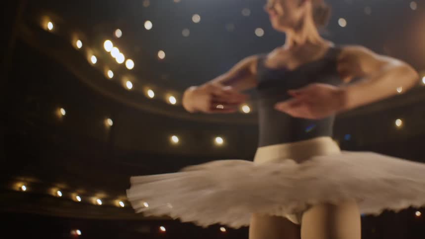 A ballerina is performing on stage