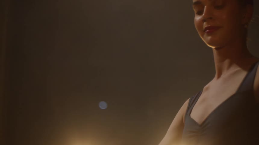 A ballerina dances on a stage in theater