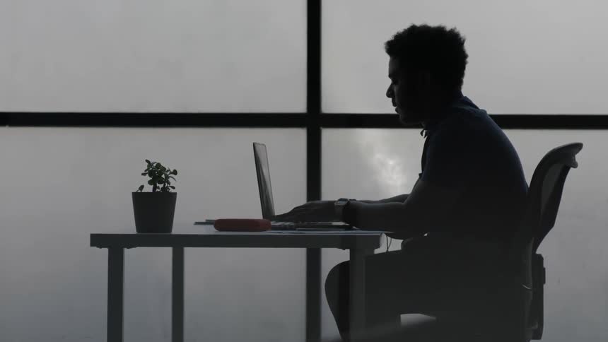 A man works on his laptop