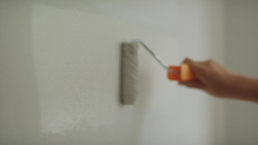 Someone is painting a wall with a paint roller