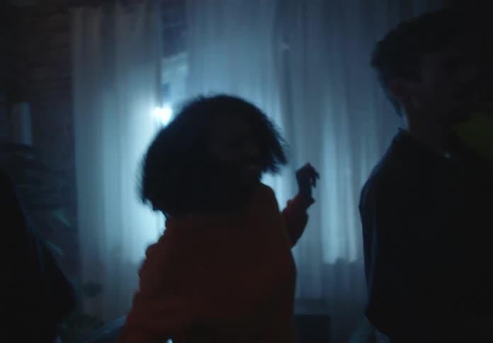 Friends dance and play with balloons in room