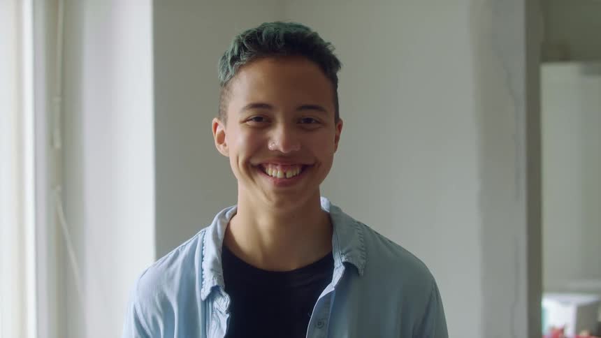 A portrait of a person standing in a room