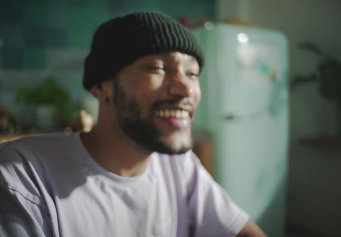 A man is laughing and talking to someone