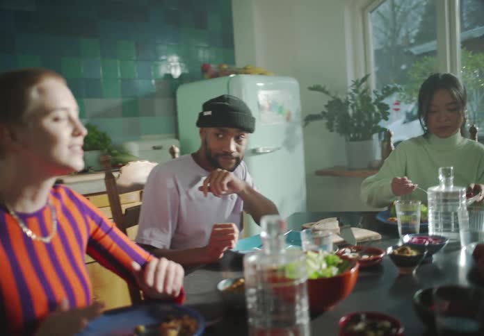 A group of friends have a meal together