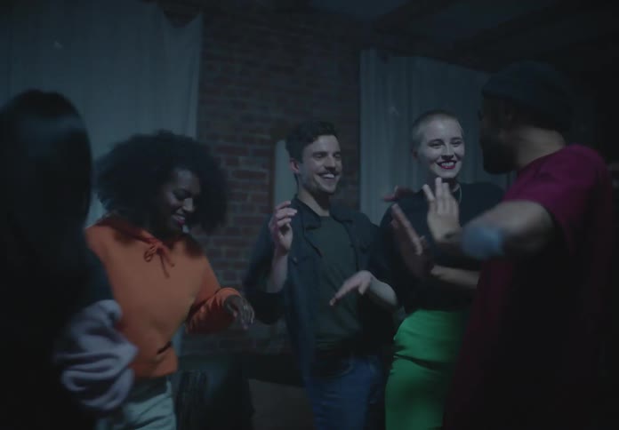 A group of people dancing together in a club
