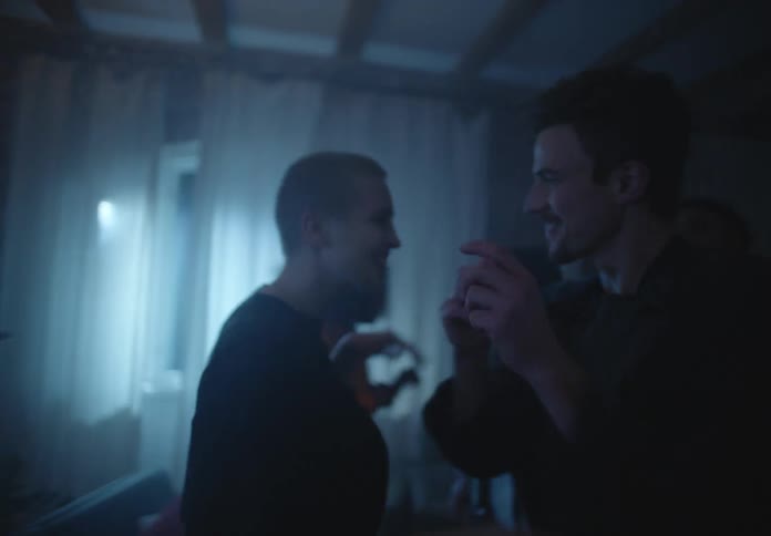 Friends dance at party in dimly lit home