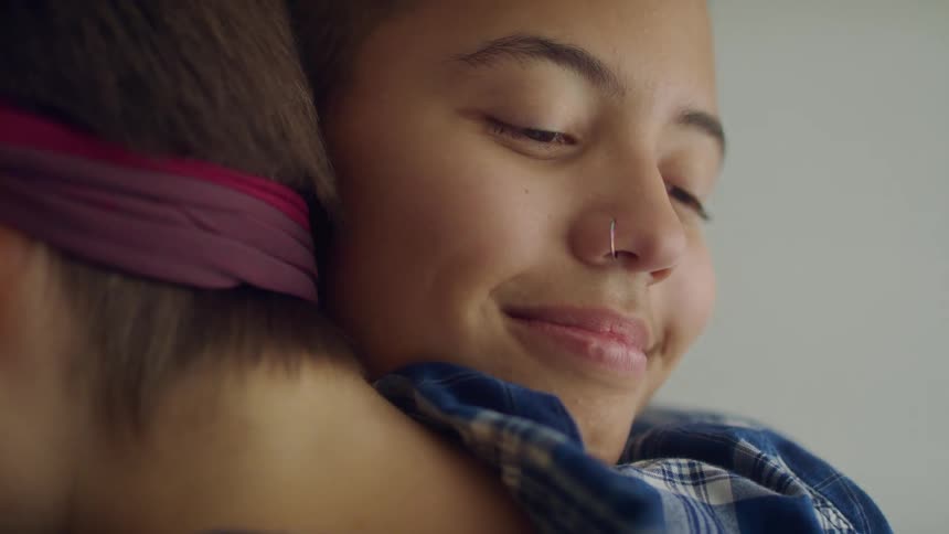 A mother and son hugging each other