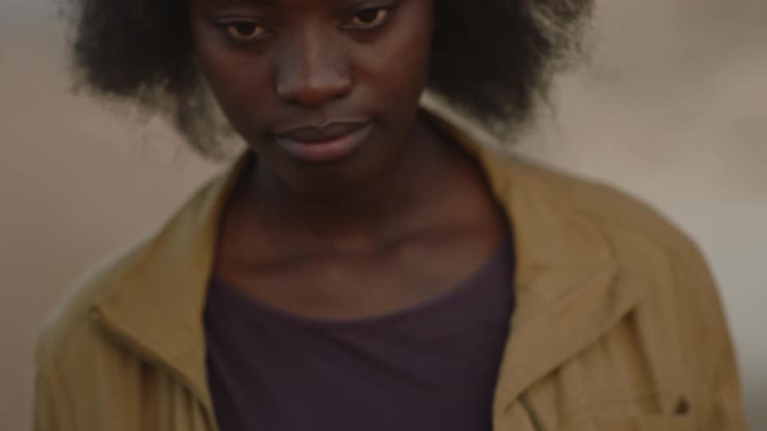 A woman looks up outside