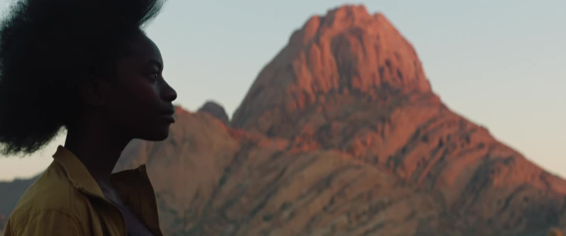 Young woman stops to look at the mountain