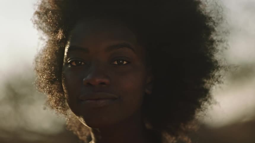 Intimate portrait of a young woman with wind blowing