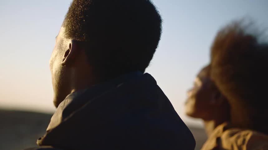 Couple watches sunset together