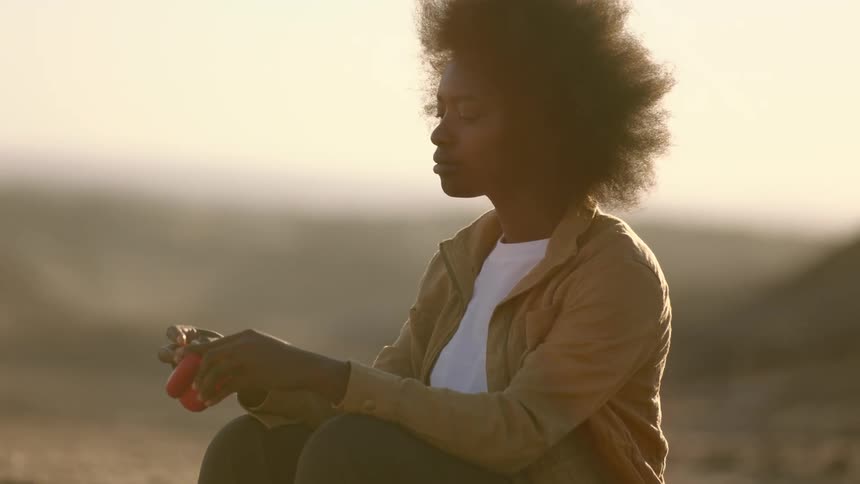 Black woman listening to music outdoors