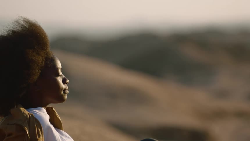 A woman rests in the desert