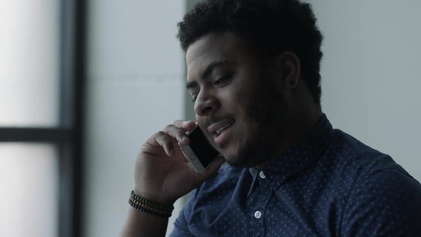 A man picks up the phone and talks