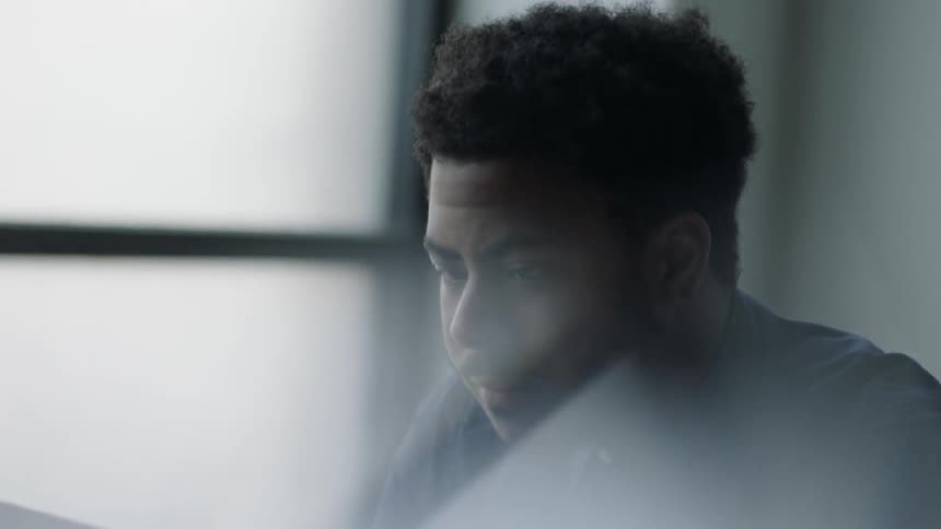 A man looks at his laptop