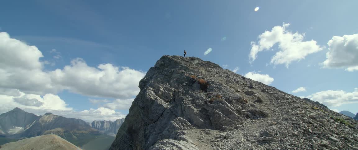 A person at the top of a mountain hiking