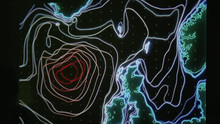 A monitor with coastlines and moving lighted lines