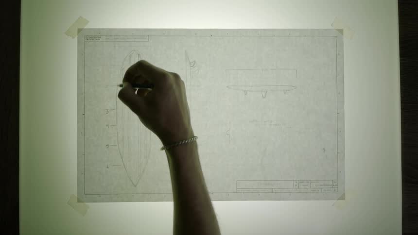 A person sketches with a pencil