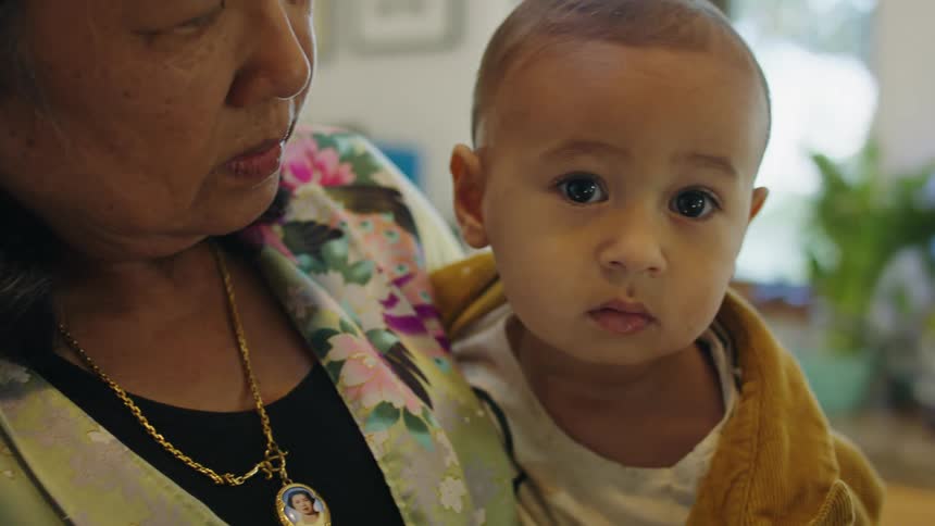 A grandmother holds her grandson
