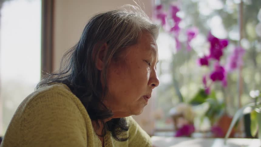 Older woman tries to avoid falling asleep
